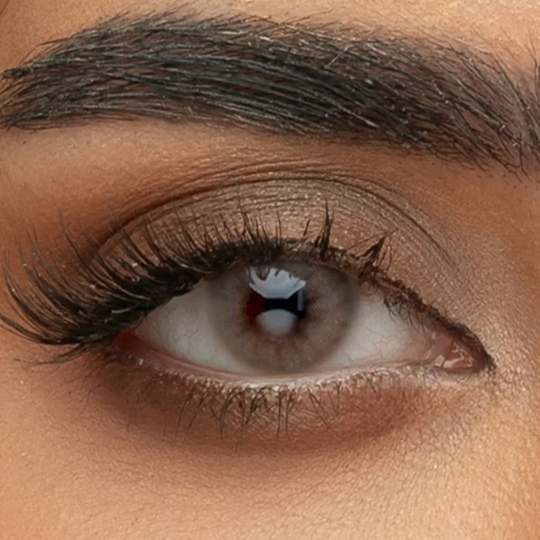 Macro photograph of a person wearing Sama Monthly Lava Gray contact lenses, showcasing the smoky charcoal pigment and high-definition iris pattern.