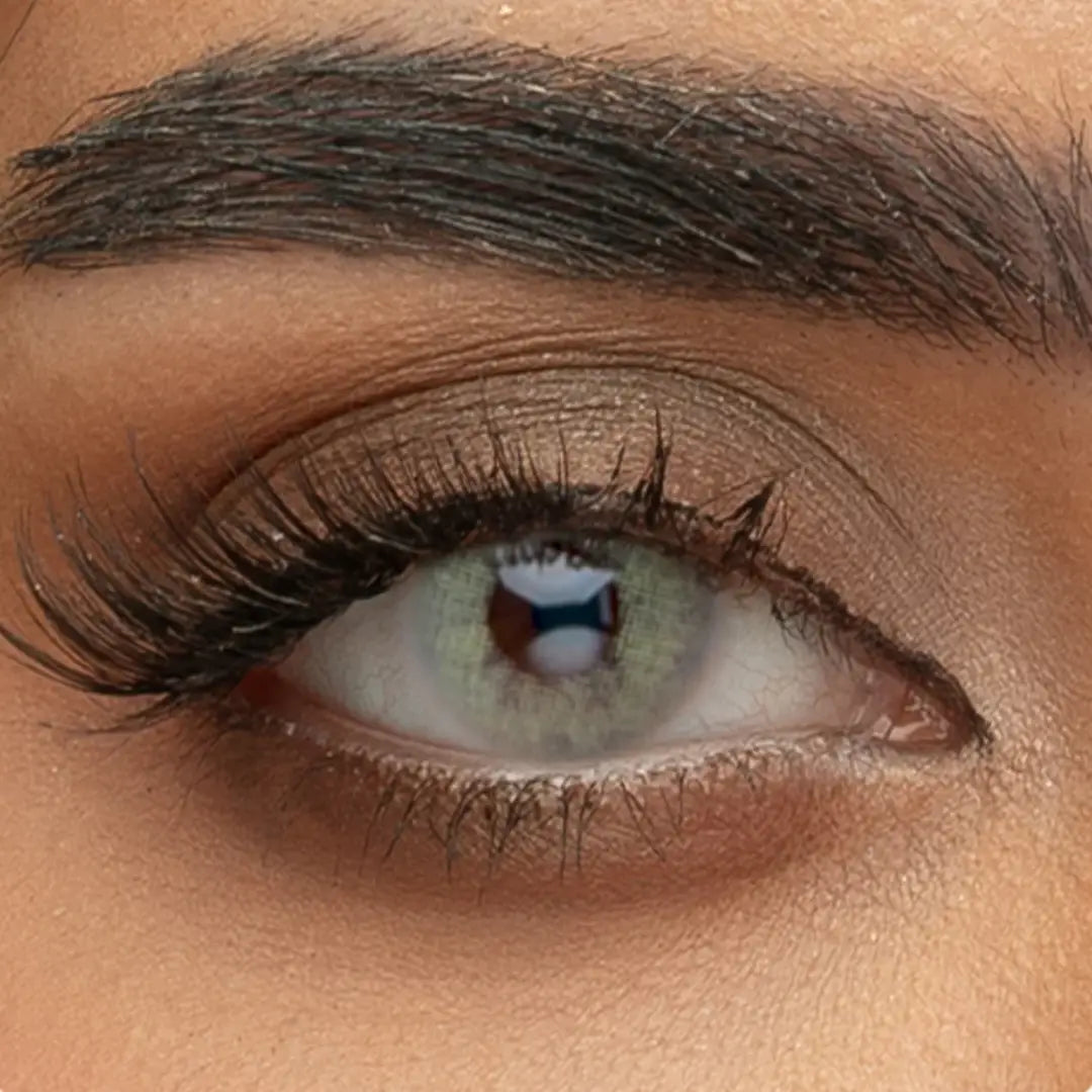 A close-up view of Sama Monthly Moor Gray contact lenses on a dark eye, showing the misty gray pigment and realistic iris detail
